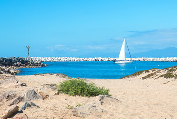 Sailboat going into Ventura Harbor in Ventura California United States