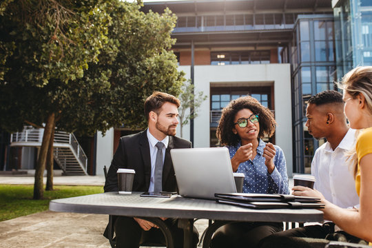 Business professionals discussing work at office cafeteria - Powered by Adobe