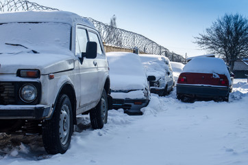 abandoned cars in the snow