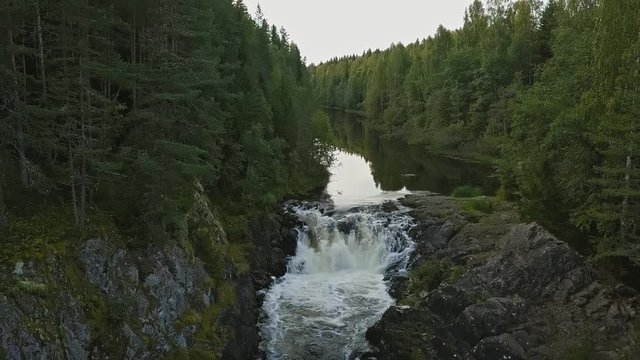 Aerial footage of a Karelian waterfall Kivach, full water flow over the top