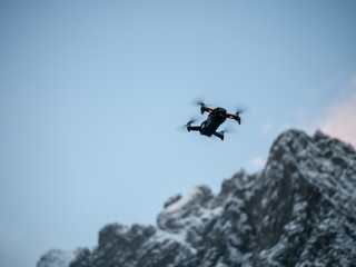 Drone hovering against Blue sky.