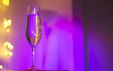 Champagne glass in disco party bar