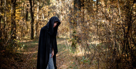 Teenagers in Halloween costumes in the woods. Halloween vampire in the woods