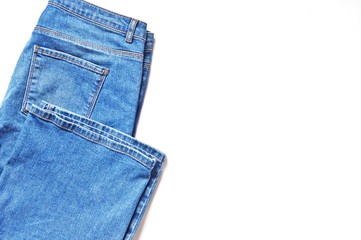 Blue jeans on a white background. Flat lay photo, copy space