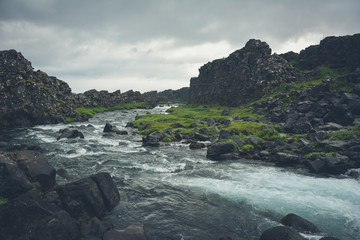 Fototapeta na wymiar Oxararfoss waterfall in Pingvellir or Thingvellir National Park in summer in Iceland - vintage colors