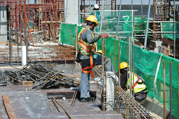 Construction workers fabricating floor slab reinforcement bar at the construction site in Malacca,...