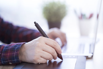 Turkish male designer working on his graphic tablet