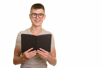 Young happy Caucasian man smiling and holding book