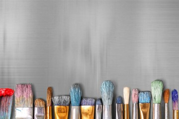 Row of artist paint brushes  on background