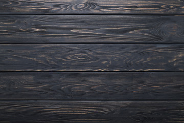 Black background of wooden old rustic table, planks texture, wood wall.