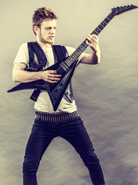 Young man playing electric guitar