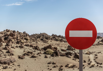 Forbidden sign on the right side of the photo, in the middle of a desert and volcanic landscape