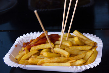 French fries on white plate with ketchup and toothpicks. Potato chips, fast food, snack, unhealthy...