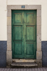 Fototapeta na wymiar Green wood door. Home entrance, closed gate, old building, no entry concepts