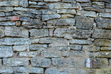 Anciend wall made of huge grey rocks