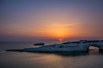 Limestone rock with arch, S`Archittu di Santa Caterina in Oristano Province, Sardinia, Italy captured in summer at sunset.