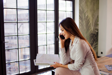Obraz premium Happy young woman in comfortable loft style office.