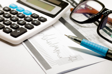 Documents, calculator and pen, glasses close-up. Business background.
