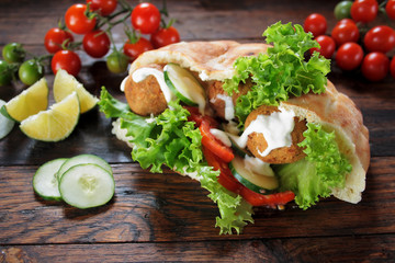 Falafel and fresh vegetables in pita bread
