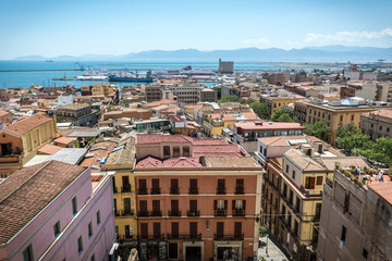 View on the city of Cagliari, the capital of Sardinia. Colorful houses and clear blue sky on a sunny day. Sea can be seen in the background.