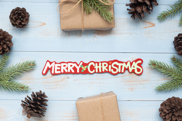 Christmas decoration, gift box and pine tree branches on wooden background, preparation for holiday concept, Happy New Year and Xmas Holidays. Top view and Copy Space for text
