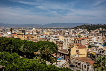View on the city of Cagliari, the capital of Sardinia, Italy. Colorful houses and blue sky on a sunny day, mountains in the background.