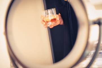 a female hand holds a glass