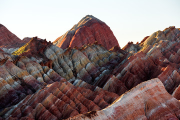Zhangye Danxia National Geopark - Gansu Province, China. Chinese Danxia multicolor Danxia landform, rainbow hills, colored rocks, sandstone erosion, layers of Red, Yellow and Orange stripes. 张掖
