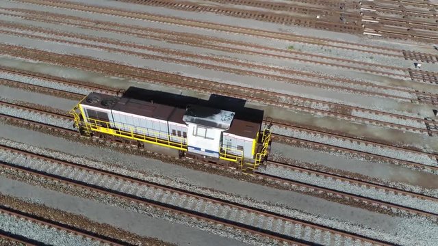 Aerial footage of locomotive also known as engine at railway hub is a rail transport vehicle that provides the motive power for a train to pull or push a railroad car 4k high resolution video