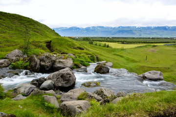 Thorsteinslundur waterfall  in motion blur on overcast summer day in Iceland.