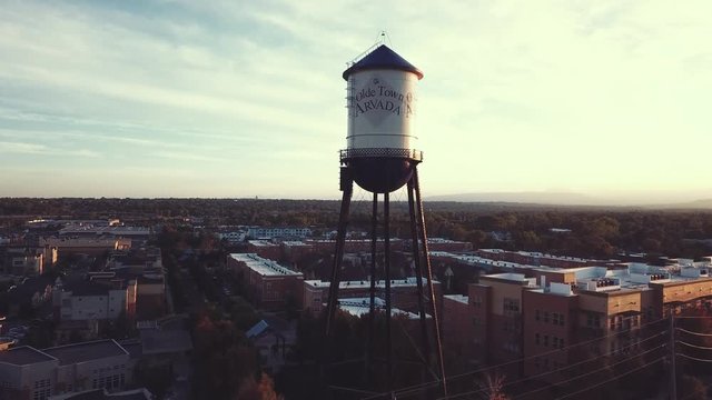 A water tower over the Town of Arvada is captured at sunset