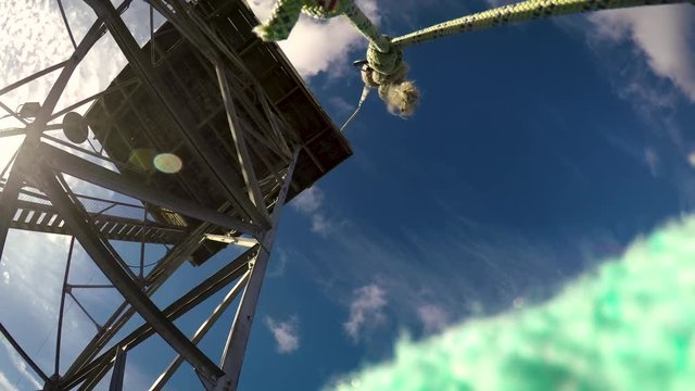 Pulley basket being pulled up to a fire lookout tower ontop of a mountain