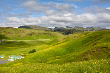 Green valley near Vik, Iceland on overcast summer day, dramatic clouds, beautiful scenery