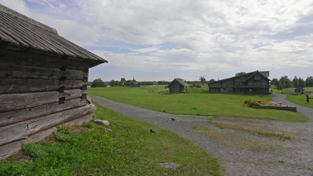 Authentic wooden structure, mill in a distance and church, Kizhi