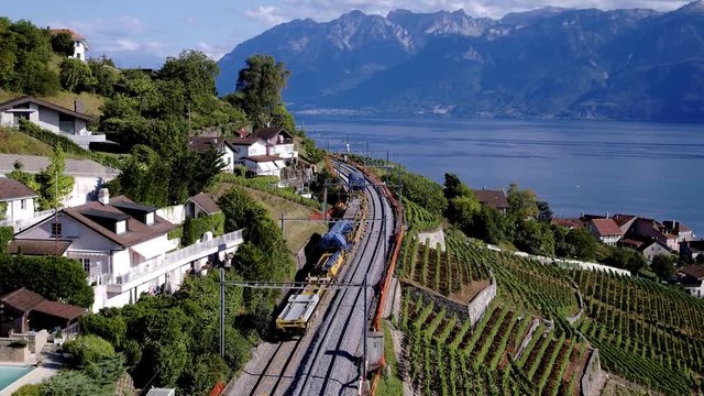 Aerial view following railway tracks under repair. 
Lake L&radic;&copy;man and Mountains in the background
Grandvaux, Lavaux - Switzerland