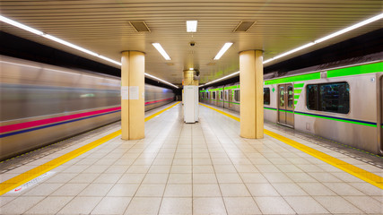 Commuters and trains in subway station in Tokyo