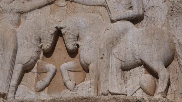 Bas-relief in damaged stone of warriors in persepolis, shiraz, Iran.