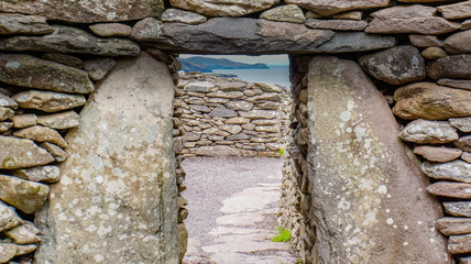 looking through a doorway of an ancient beehive Irish hut formed in stone cashels or enclosed farmsteads in the Early Christian Period © vermontalm
