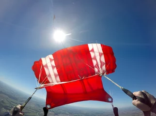 Fototapeten First-Person-Ansicht eines roten Fallschirms © Mauricio G