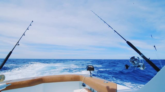 Fishing poles trolling for big game on yacht in Caribbean Sea