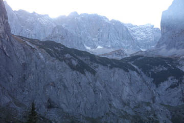 Mountain face with snow caps at Höllental in German Alps