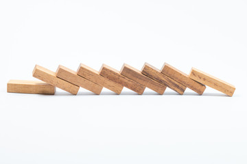 Domino effect, row of wood domino on white background