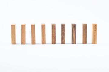 Domino effect, row of wood domino on white background