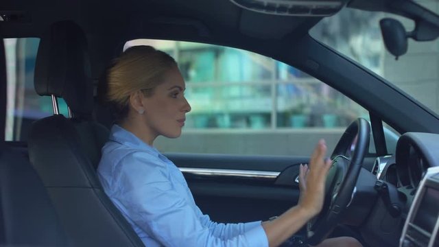 Happy woman listening to music while driving, inspired by positive in morning