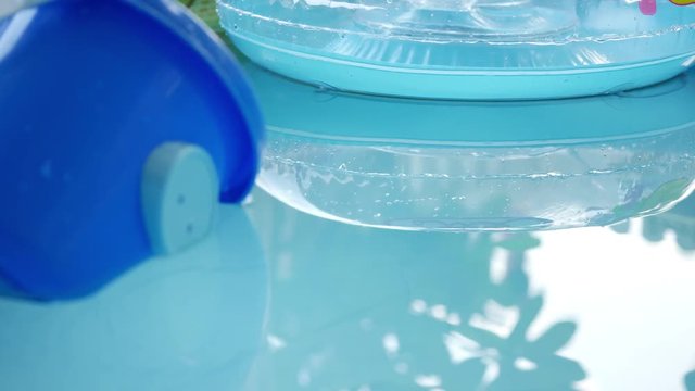 baby toy floating on clean water of blue swimming pool