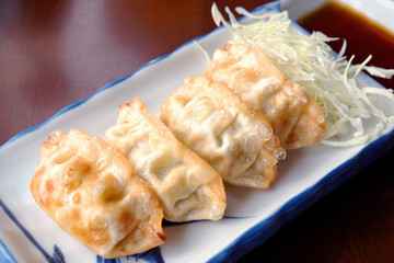 Pan-fried gyoza with dipping sauce