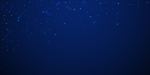 Sparse glowing snow Christmas background. Subtle f