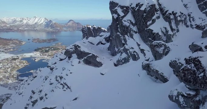 Lofoten Islands winter scenery with hiker on mountain top, Ballstad, Norway, Scandinavia