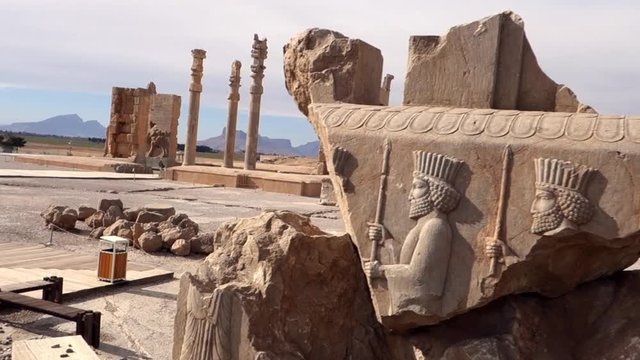 Bas-relief in damaged stone of warriors in persepolis, shiraz, Iran.