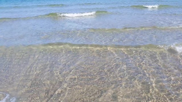 Pristine shallow water with gentle waves and ripples on the ocean floor. An early spring morning. Liseleje Beach by the Tisvilde forest and coastal area on the Danish island of Zealand.